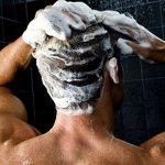 man washes his hair
